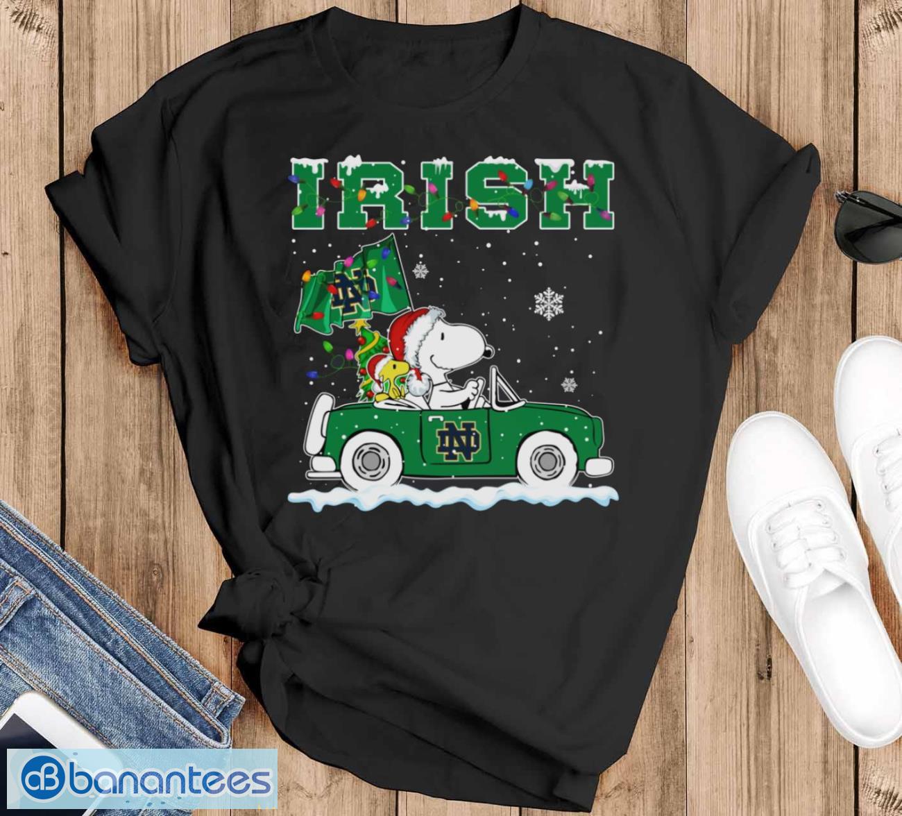 notre dame fighting irish snoopy and woodstock driving car cute snoopy limited edition shirt image Notre Dame Fighting Irish Snoopy And Woodstock Driving Car Cute Snoopy Limited Edition Shirt - Black T-Shirt